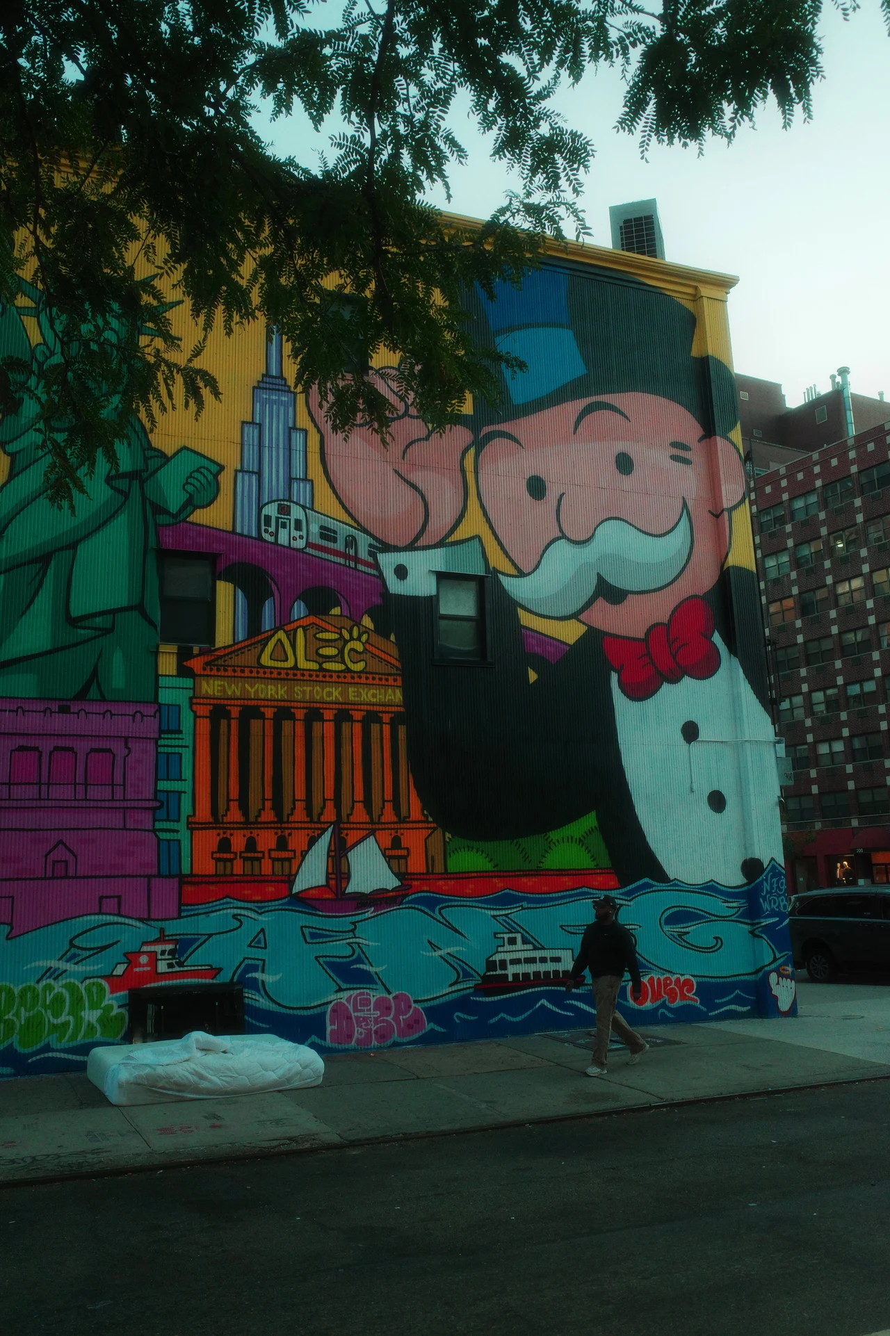 A person walking past a colorful Monopoly mural