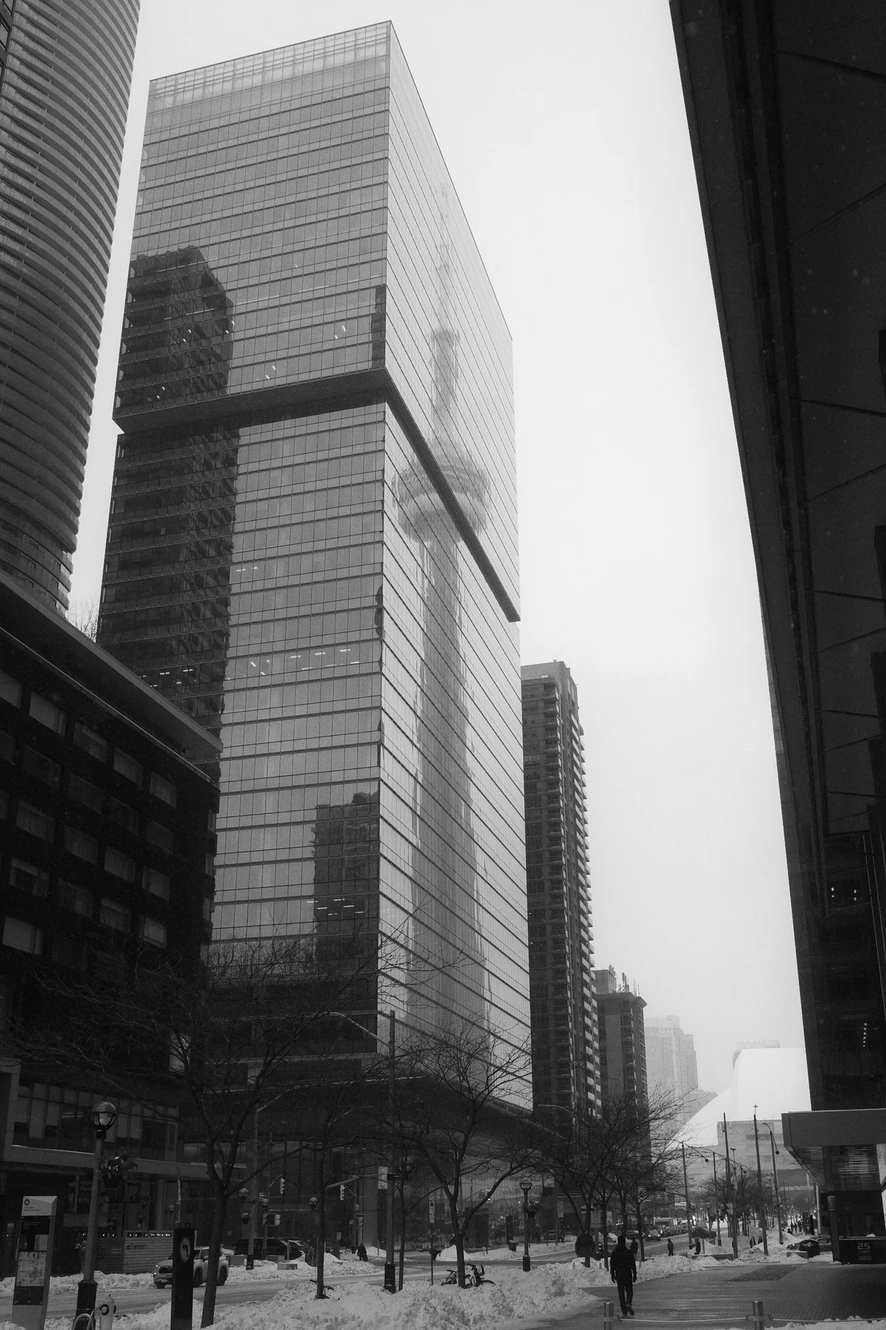 A winter street framed by glass towers
